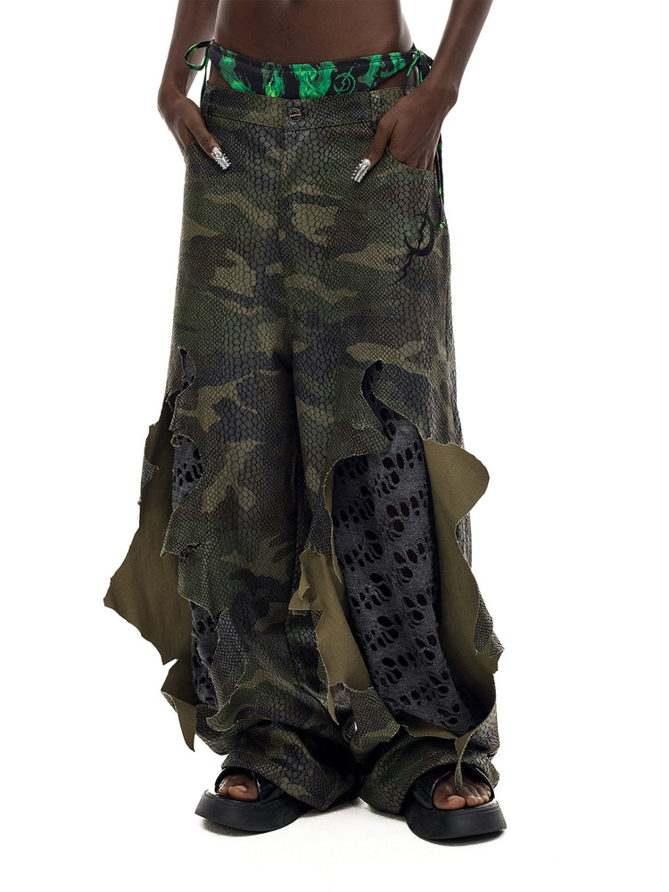 PINKSPINK DOUBLE STACK distressed camouflage wide-leg jeans — angled waist-to-hem modeled view showing hanging outer panels