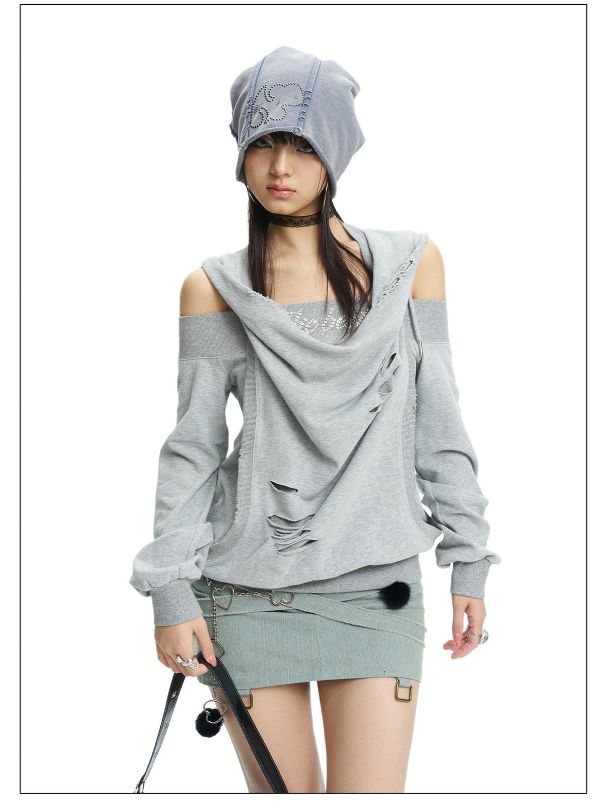 Front white-background view showing the asymmetric neckline and distressed cutouts