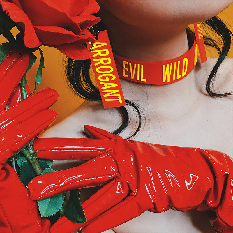 EOH-STUDIO BTBM red ARROGANT and EVIL earrings shown beside matching choker lettering.