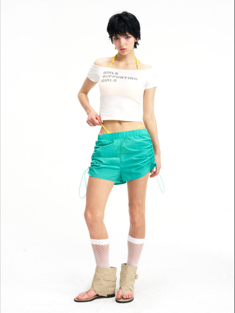 NEXT PASSPORT side-ruched drawstring mini shorts in green, front view