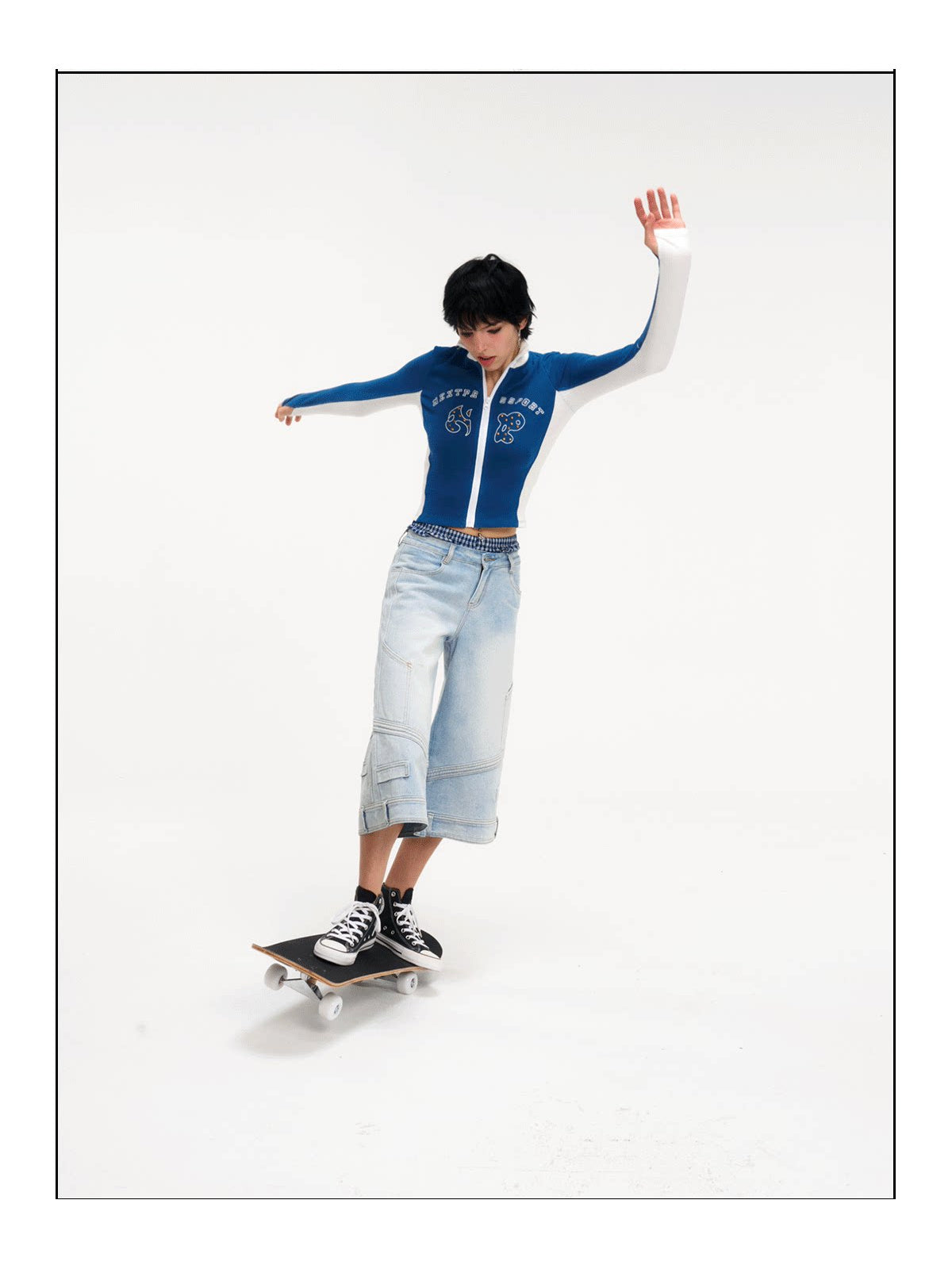 Modeled skateboard view of the light-blue cropped jeans