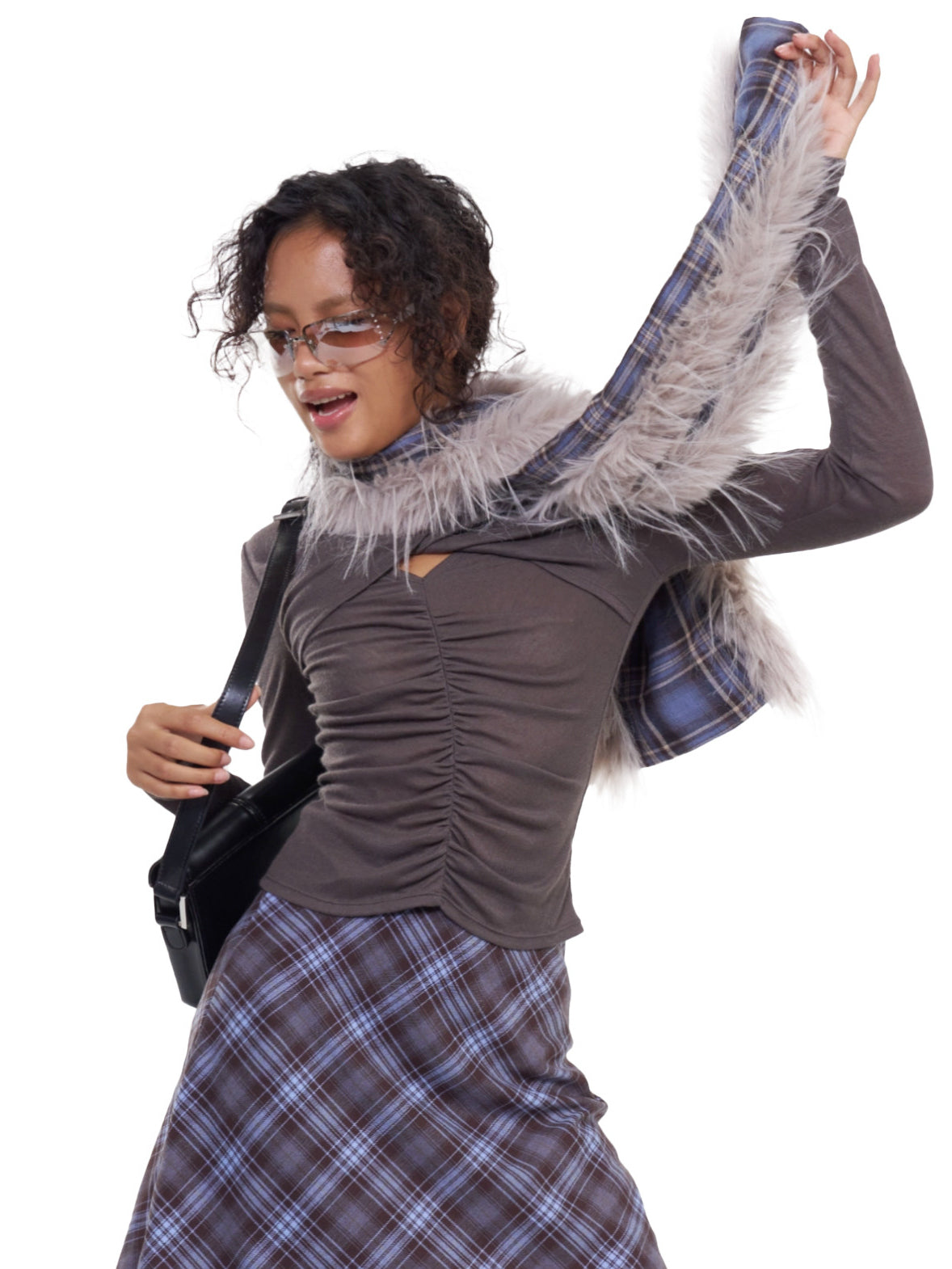 NEXT PASSPORT blue-purple plaid faux-fur scarf — modeled three-quarter view with one plaid end raised