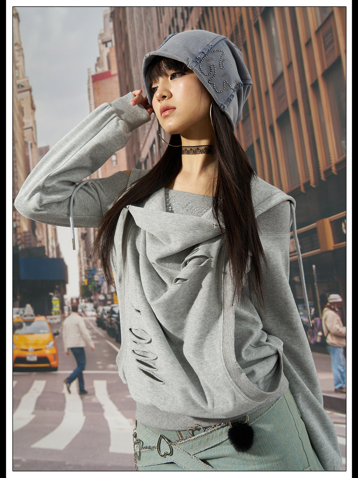 Outdoor modeled view of the gray distressed hoodie