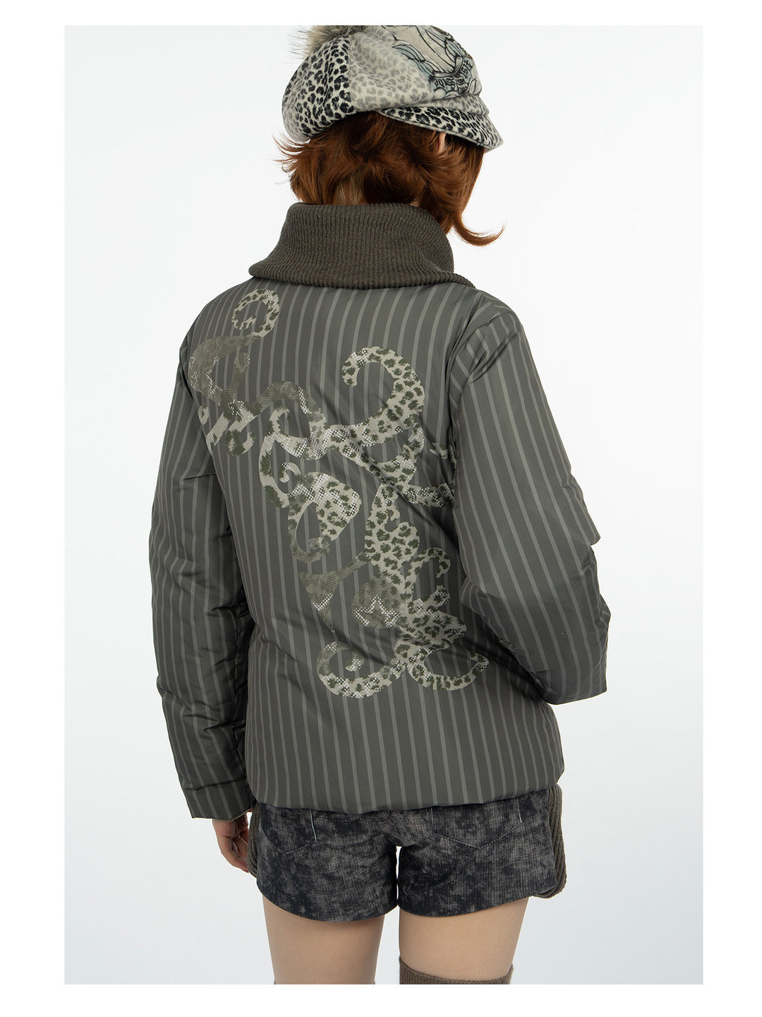 4RE1GN COMIC STRIPE asymmetric-collar down jacket in olive green — back modeled view showing the ornamental print