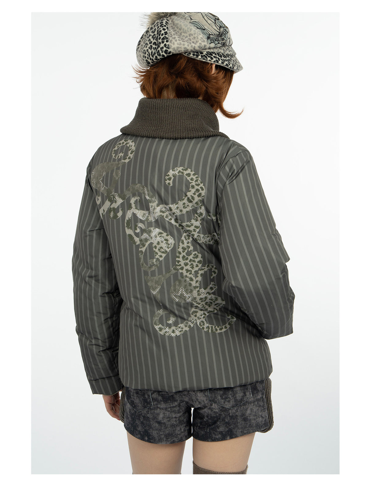 4RE1GN COMIC STRIPE asymmetric-collar down jacket in olive green — back modeled view showing the ornamental print