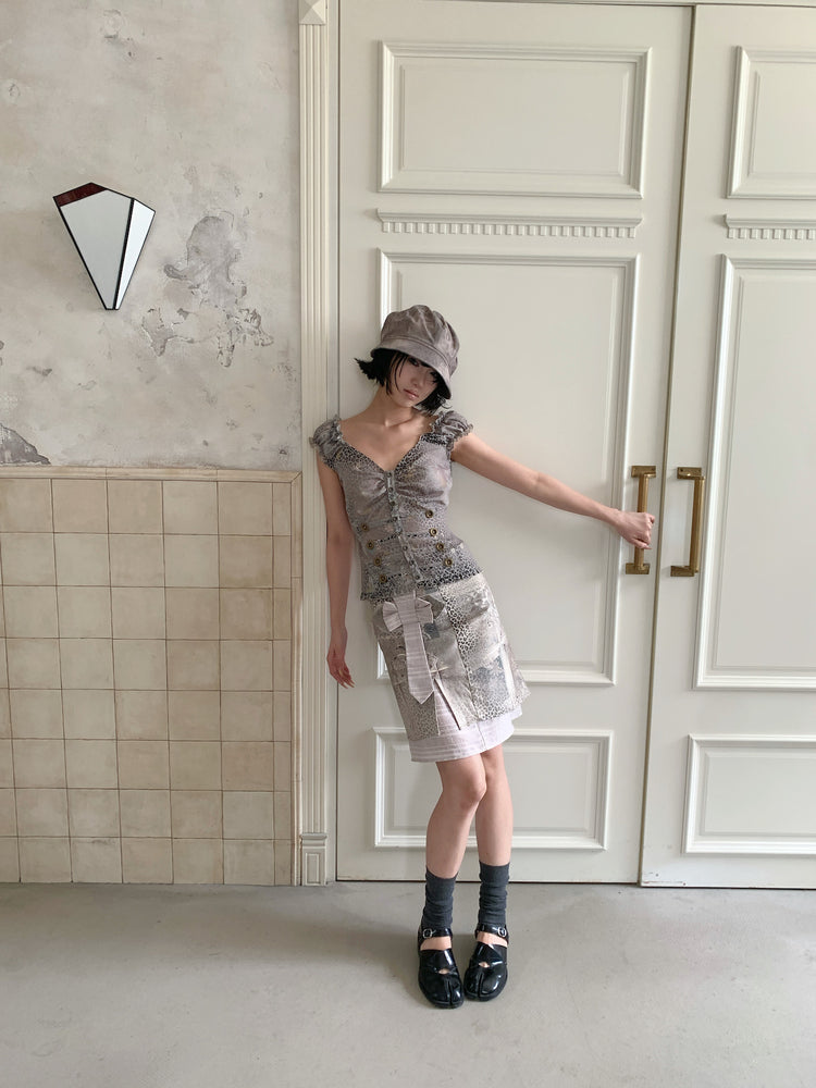4RE1GN CROSS LEOPARD bow-detail layered skirt in beige multicolor — full-length modeled view styled with a ruffled vest and hat