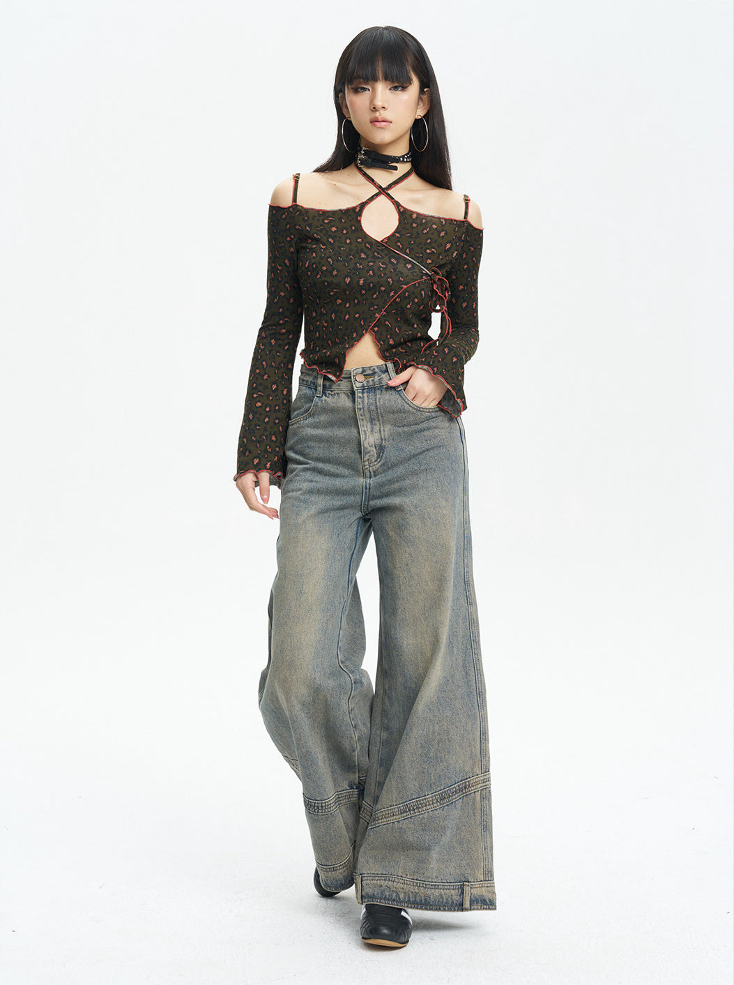 Full-length view of the leopard knit top styled with wide-leg jeans