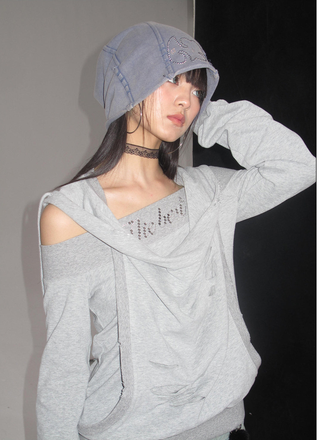 Side portrait showing the asymmetric hoodie neckline