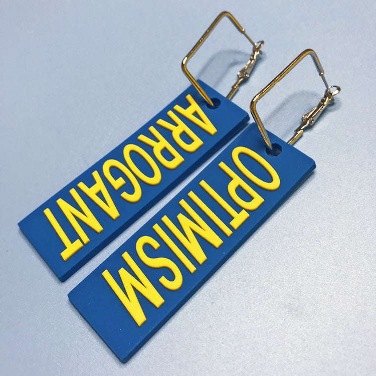EOH-STUDIO BTBM blue ARROGANT and OPTIMISM earring examples showing rectangular metal attachment hardware.
