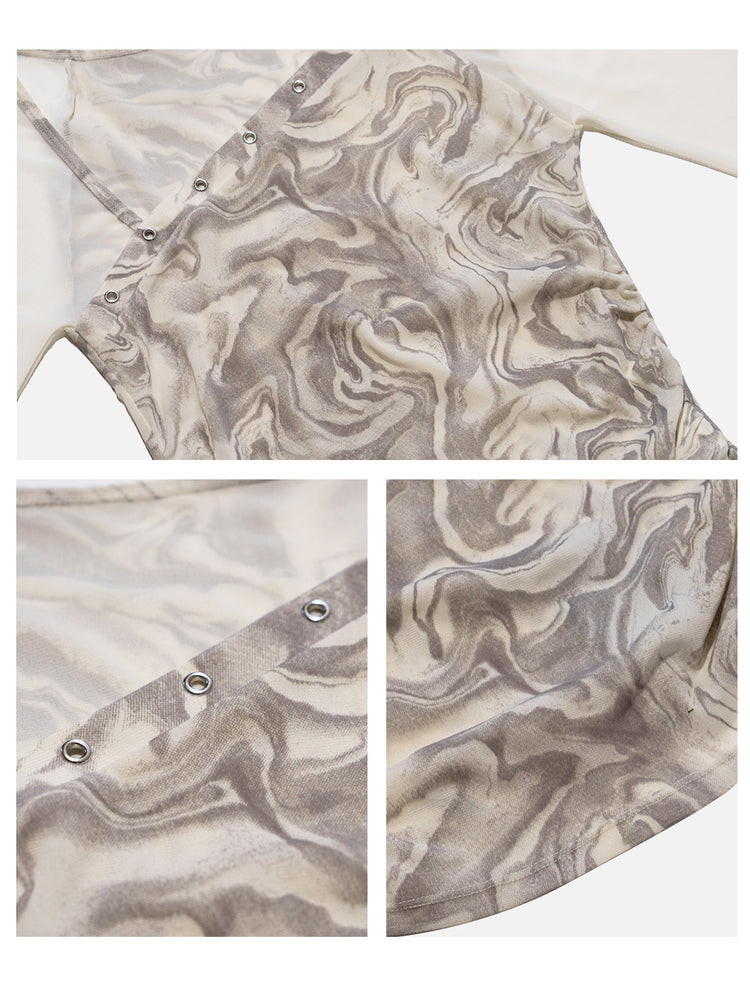 Close-up of the mesh fabric, silver-tone eyelets and marble print on the NEXT PASSPORT top.