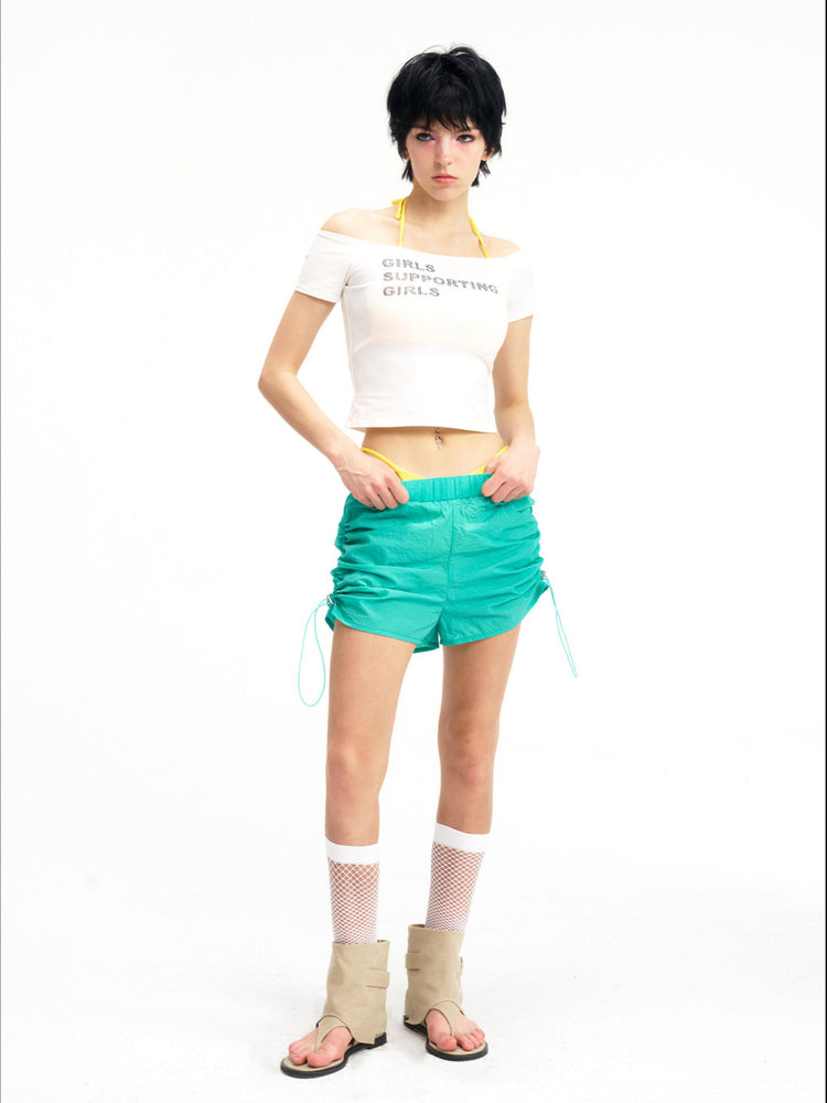 NEXT PASSPORT side-ruched drawstring mini shorts in green, front pose