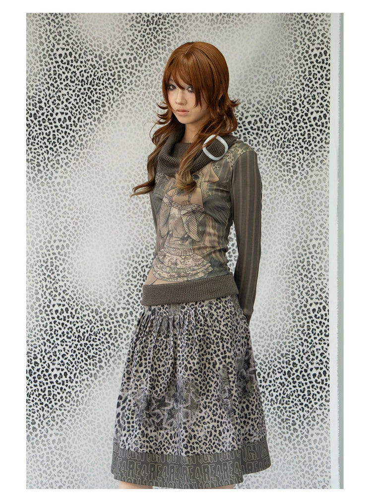 4RE1GN COMIC STRIPE scarf-neck long-sleeve tee in olive green — three-quarter modeled view styled with a leopard-print skirt