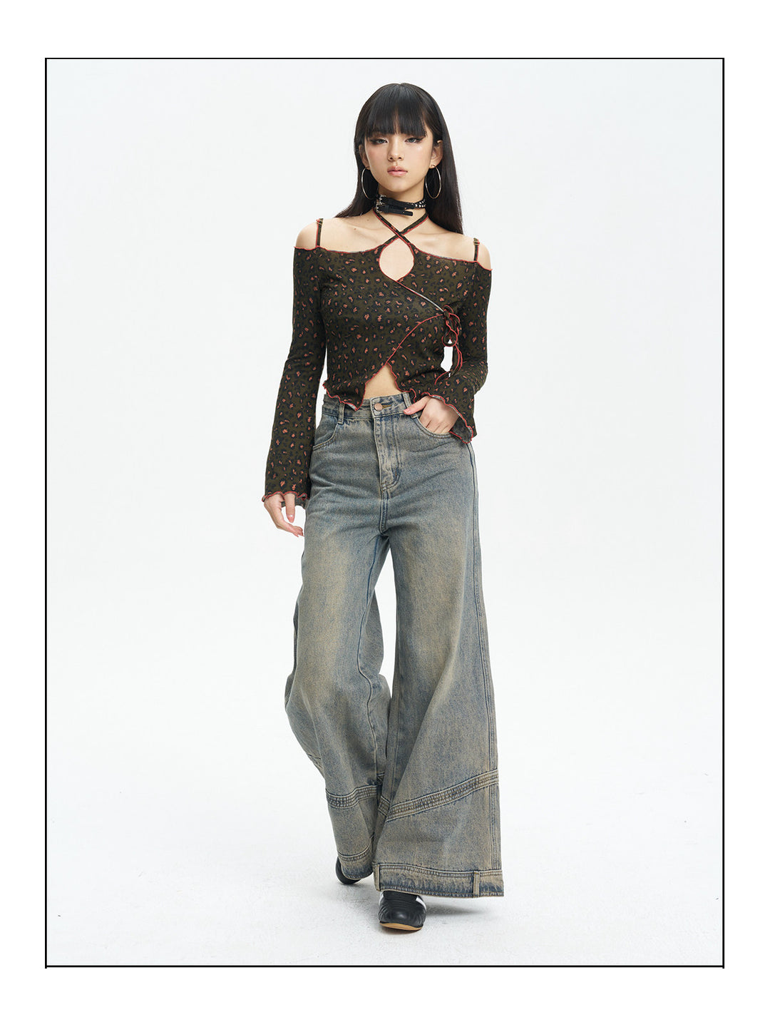 Full-length view of the leopard knit top styled with wide-leg jeans