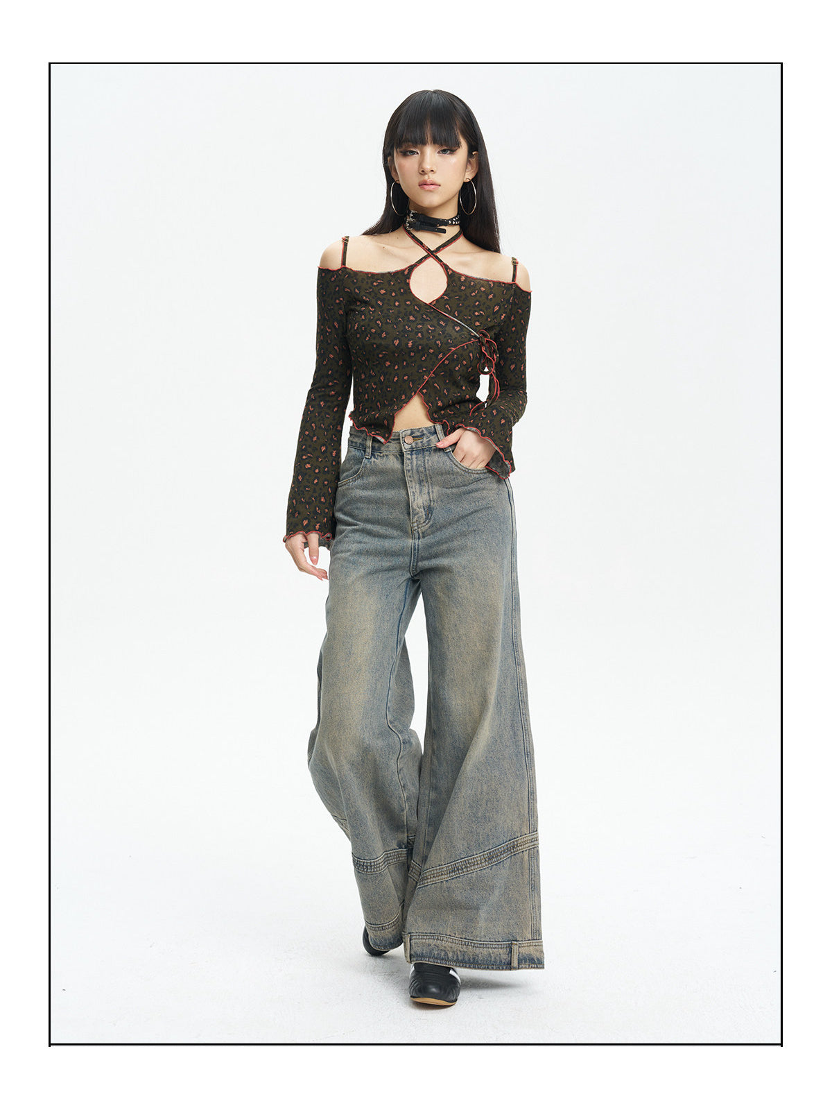 Full-length view of the leopard knit top styled with wide-leg jeans