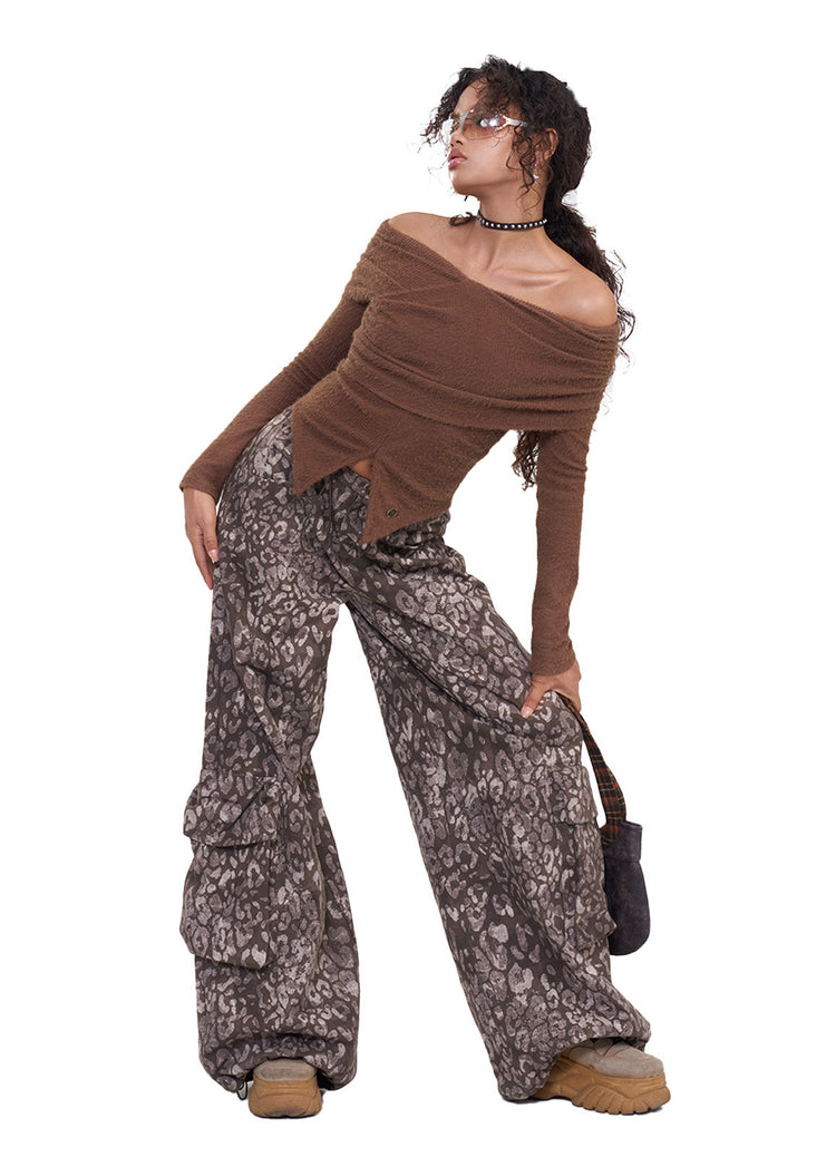 NEXT PASSPORT dark-brown twisted off-shoulder long-sleeve tee, white-background leaning pose