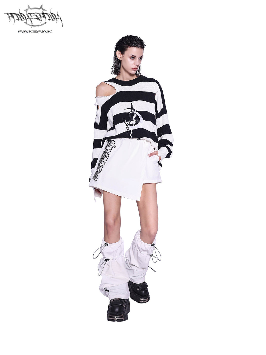 PINKSPINK ELECTRIC MOON distressed striped sweater in BLACK WHITE STRIPE — full-body angled front view styled with a white skirt.