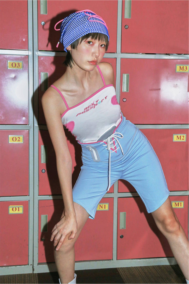 NEXT PASSPORT RETROFUTURE color-block crop camisole — white modeled leaning front pose highlighting pink contrast side panels.
