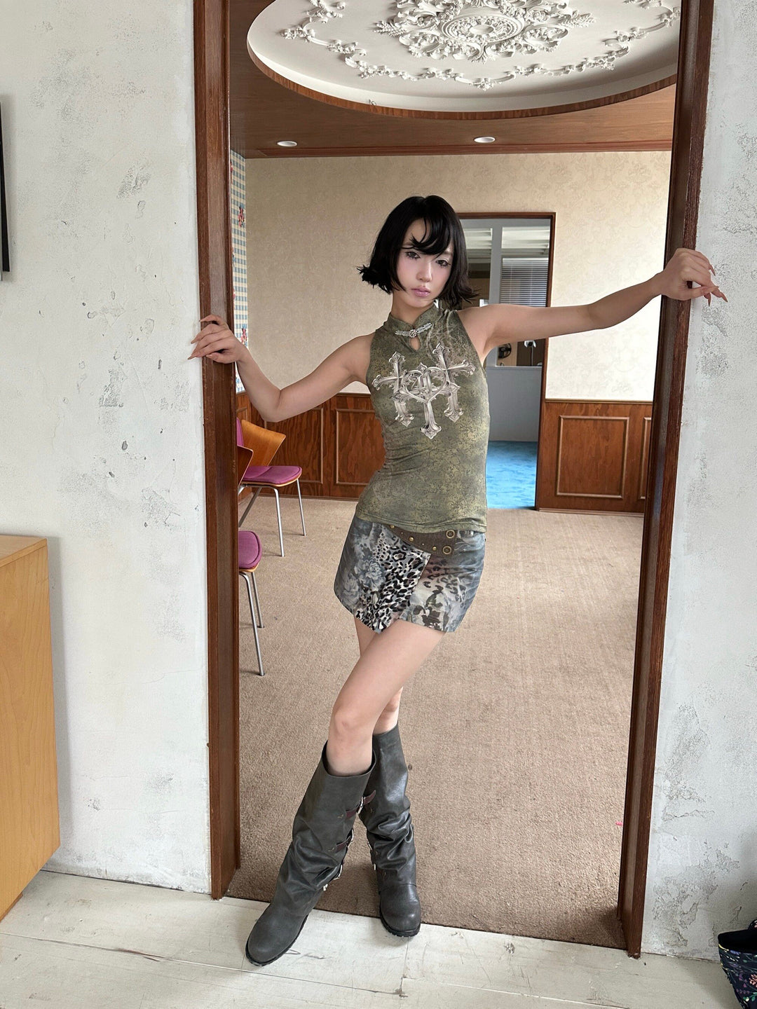 4RE1GN TRIPLE CROSS mandarin sleeveless top in olive green — front modeled view with arms extended