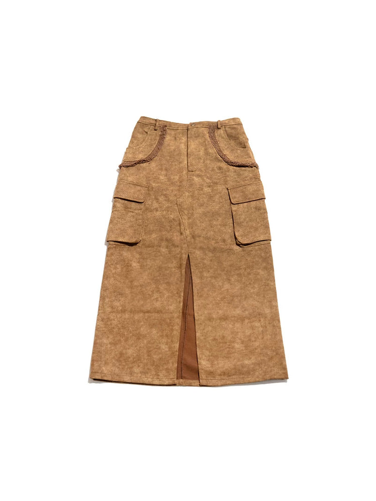 Flat-lay front view of NEXT PASSPORT brown raw-edge slit denim maxi skirt
