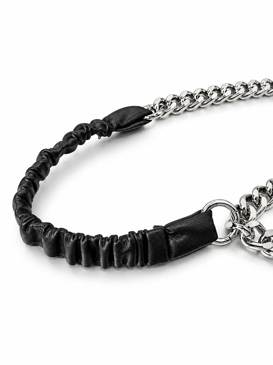 WRAVEN gathered faux-leather texture and silver-tone connector attachment, studio detail.
