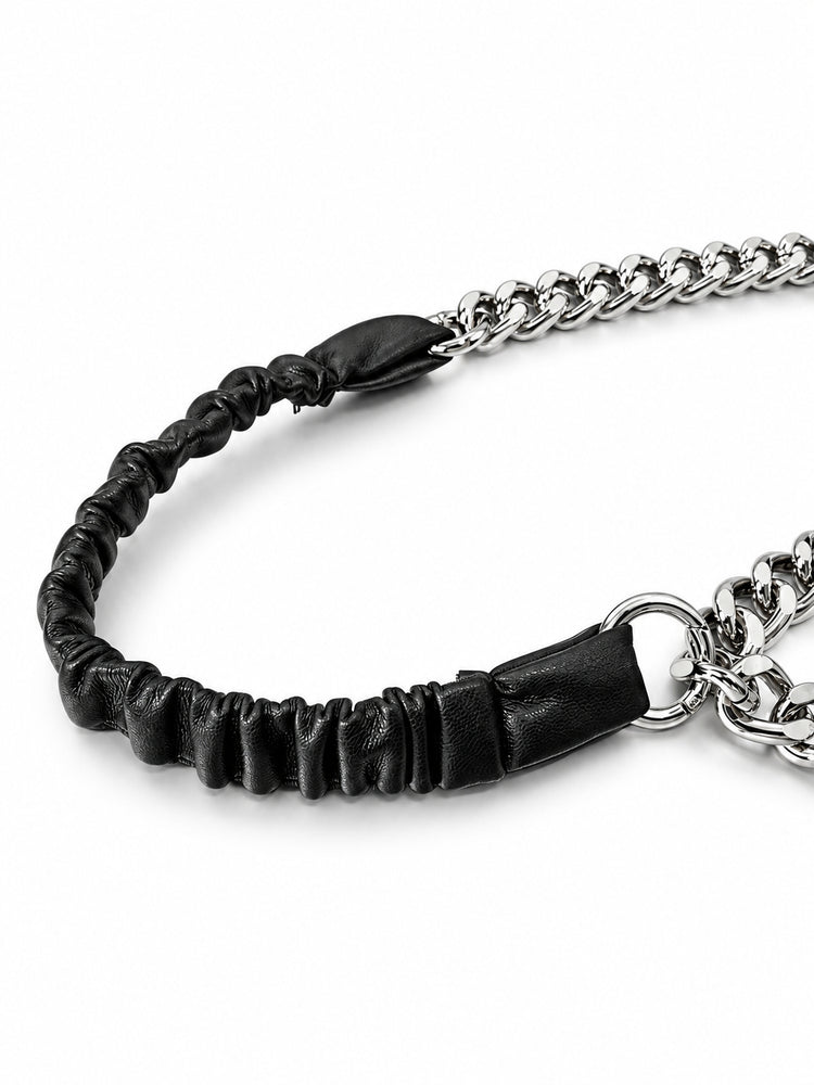 WRAVEN gathered faux-leather texture and silver-tone connector attachment, studio detail.