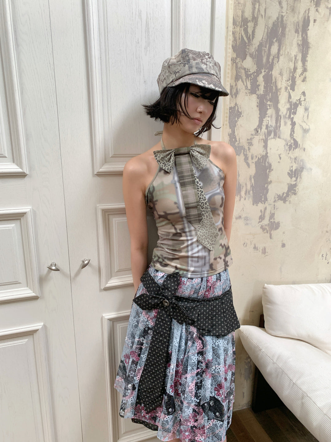 4RE1GN CROSS RIBBON jacquard lace layered skirt in multicolor — close front modeled view styled with a camouflage halter top