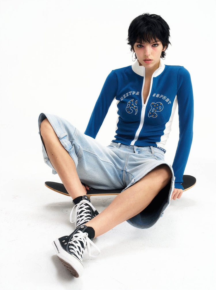 Seated front studio view of the light-blue cropped jeans