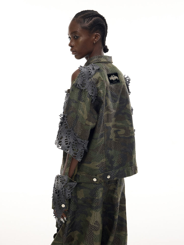 PINKSPINK ELECTRIC MOON distressed camouflage denim jacket — back three-quarter modeled view of the distressed sleeve and shoulder