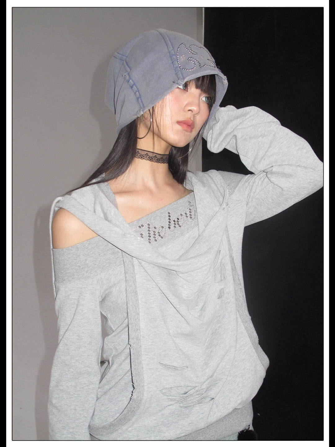 Side portrait showing the asymmetric hoodie neckline