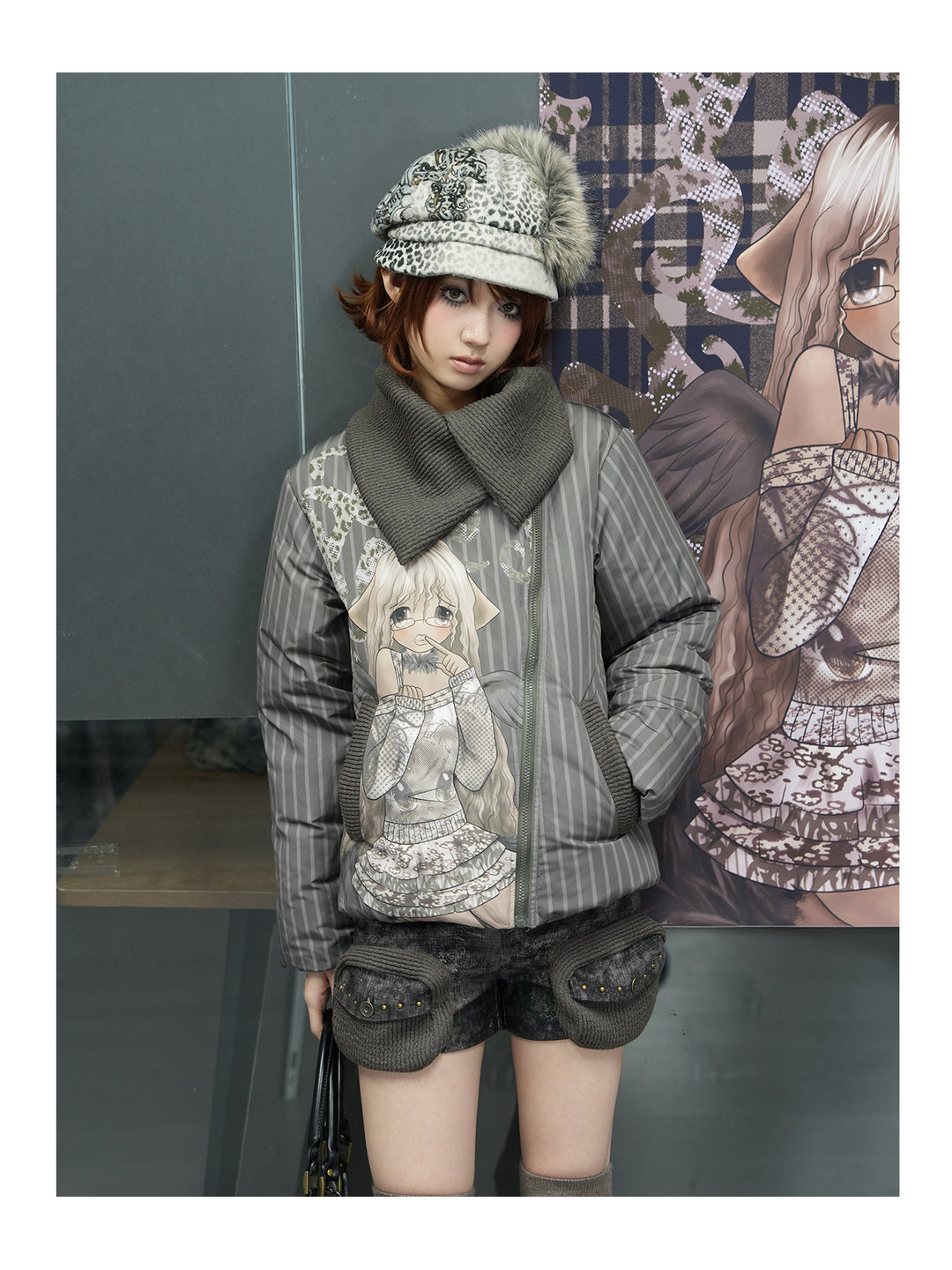 4RE1GN COMIC STRIPE asymmetric-collar down jacket in olive green — front modeled view standing beside a printed backdrop