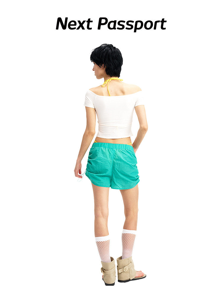 NEXT PASSPORT side-ruched drawstring mini shorts in green, back view