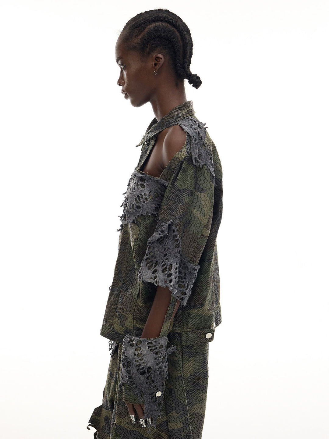 PINKSPINK ELECTRIC MOON distressed camouflage denim jacket — side modeled view showing the open shoulder and hanging cuff