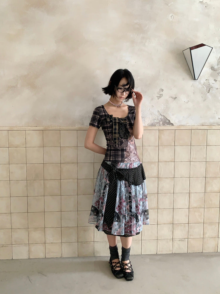 4RE1GN CROSS RIBBON jacquard lace layered skirt in multicolor — full-length modeled view adjusting glasses