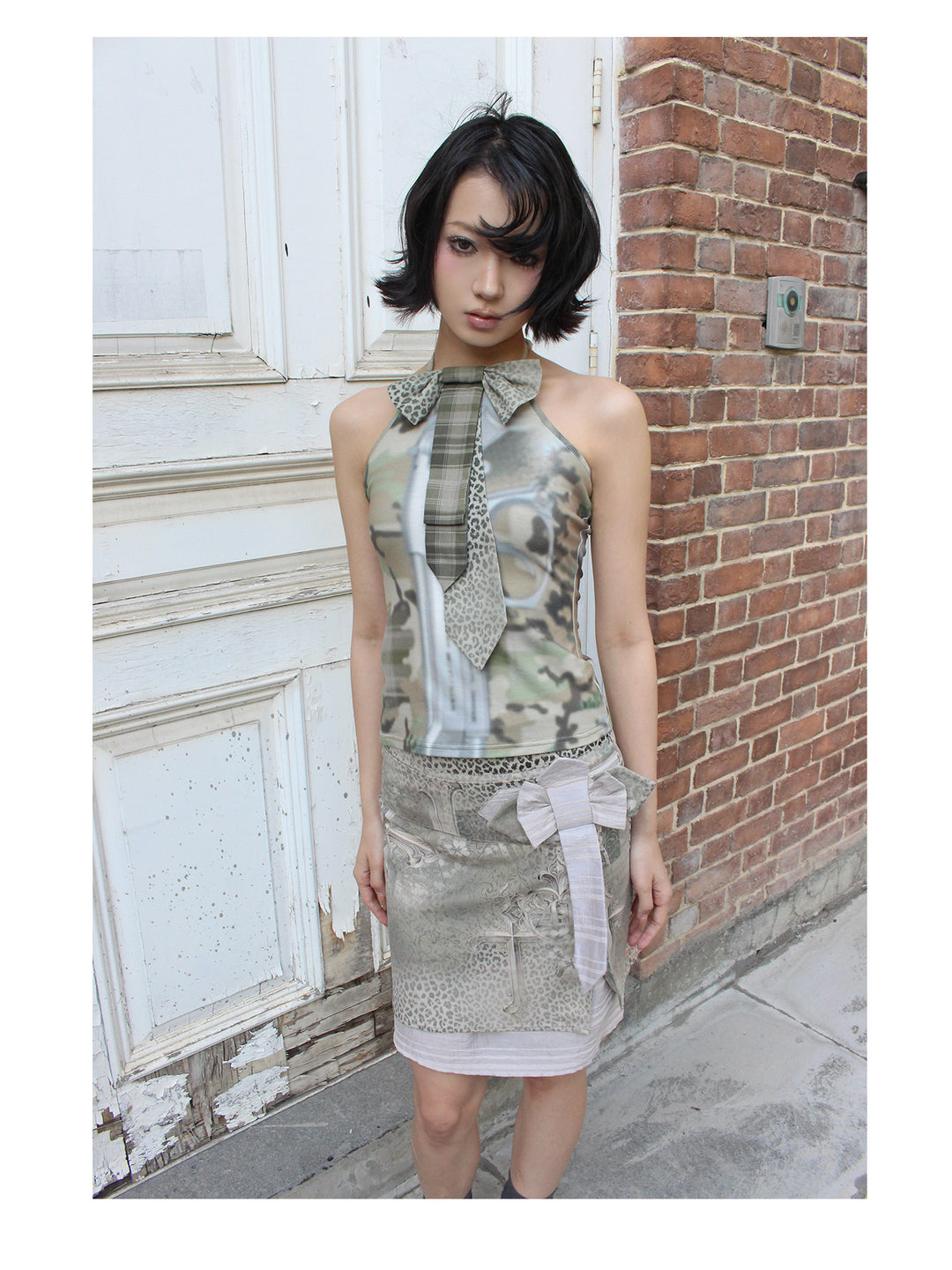 4RE1GN CROSS LEOPARD bow-detail layered skirt in beige multicolor — close front modeled view in a doorway