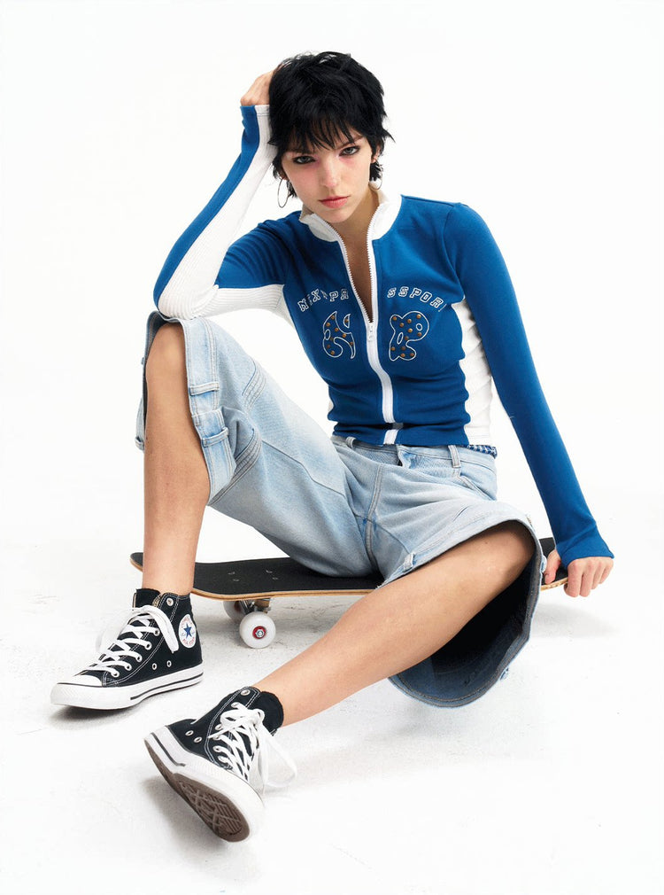 Seated angled studio view of the light-wash cropped jeans