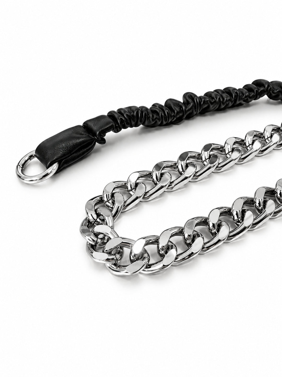 WRAVEN polished silver-tone curb links beside the black gathered faux-leather strap, studio close-up.