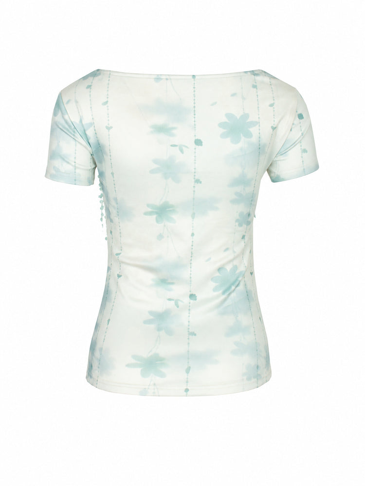 4RE1GN BLUE BLOOM patchwork short-sleeve tee in blue multicolor — back garment-only view showing the pale blue floral print
