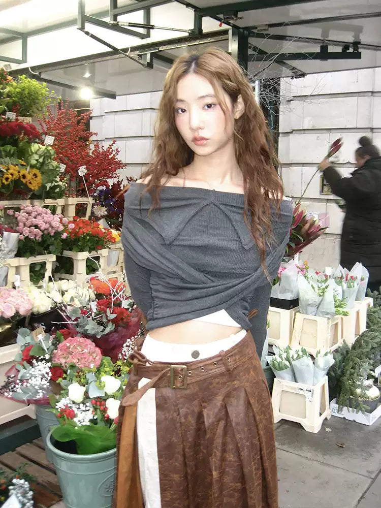 Brown faux-suede pleated skirt street styling with floral backdrop