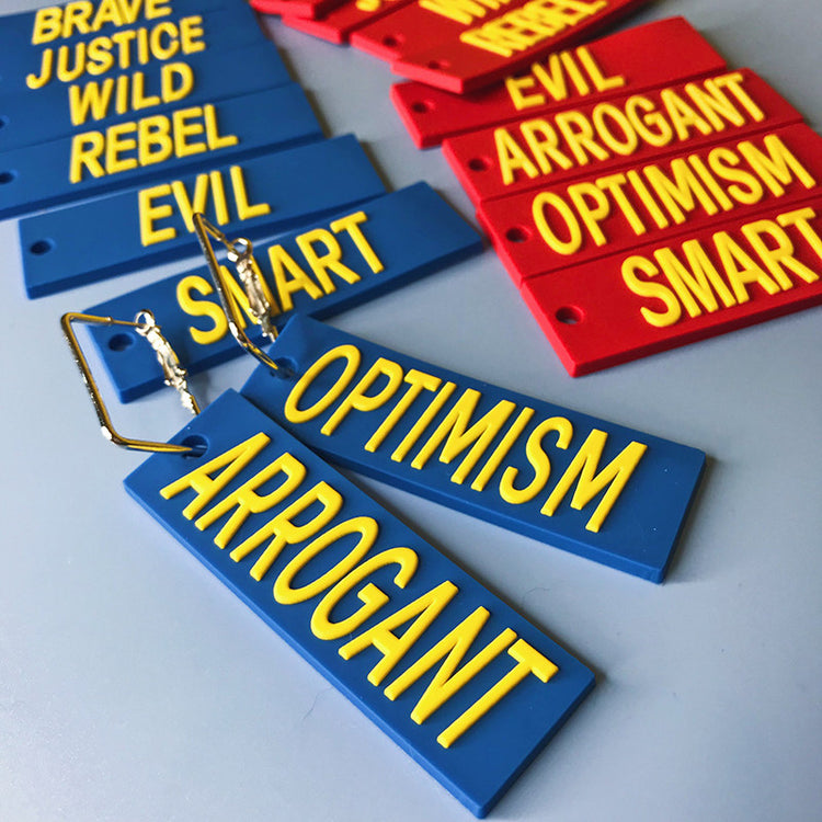 EOH-STUDIO BTBM blue word earrings showing metal attachment details beside additional word panels.