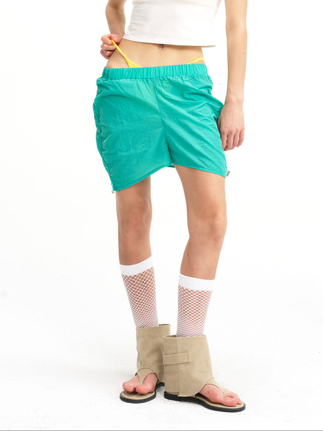 NEXT PASSPORT side-ruched drawstring mini shorts in green, relaxed-length detail