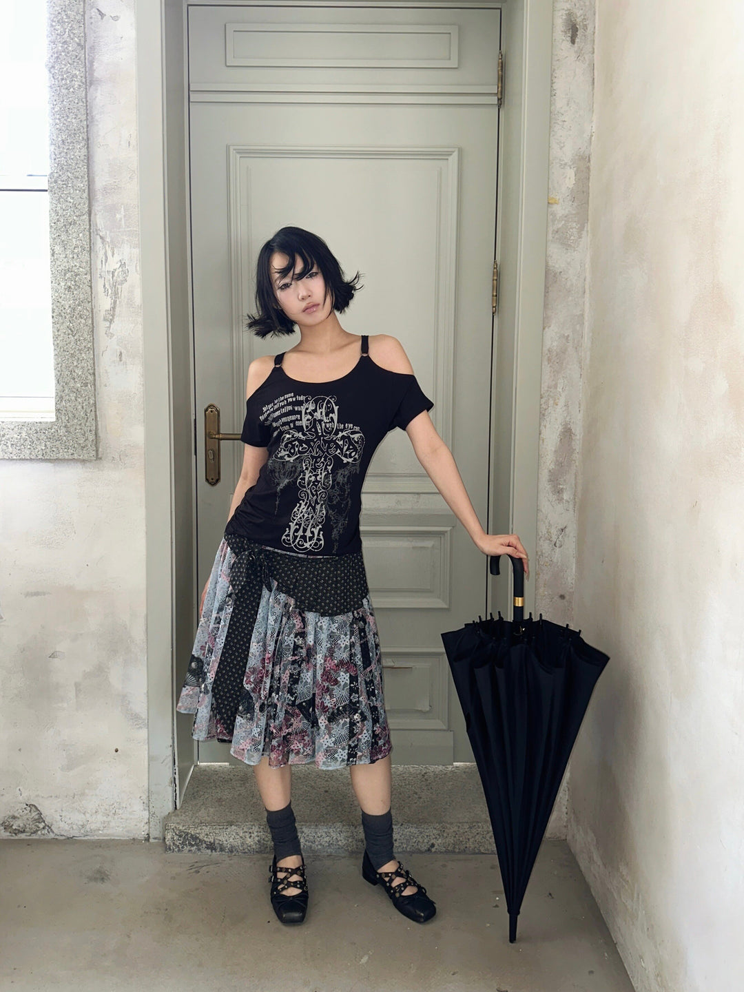 4RE1GN CROSS RIBBON jacquard lace layered skirt in multicolor — full-length front modeled view beside an umbrella