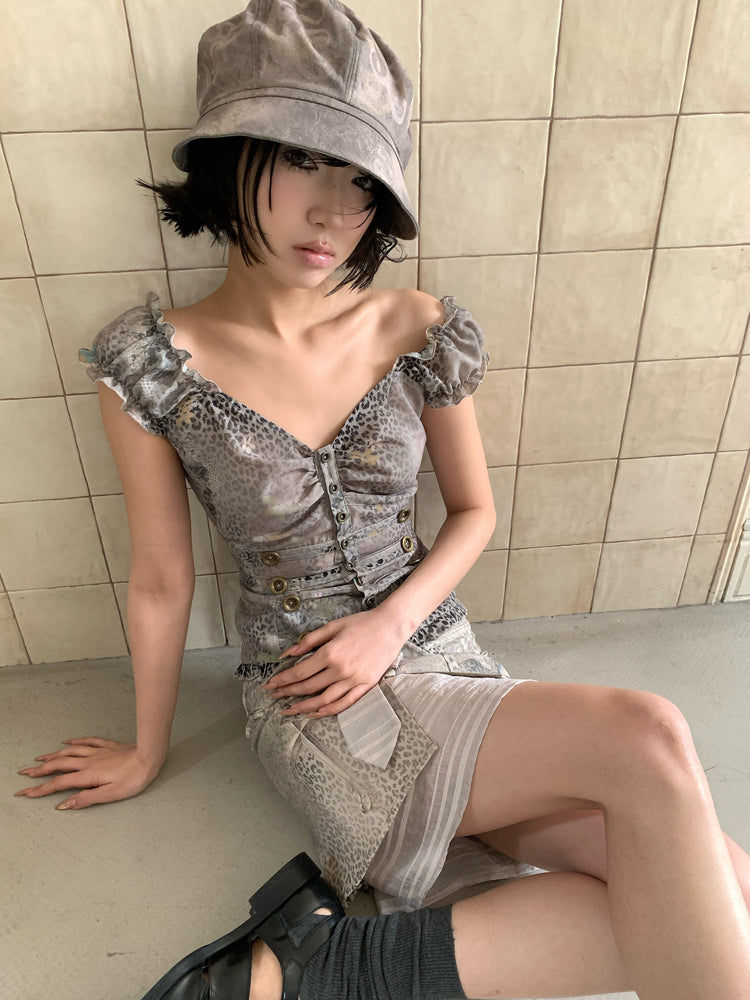 4RE1GN CROSS LEOPARD bow-detail layered skirt in beige multicolor — seated modeled view showing the striped underlayer