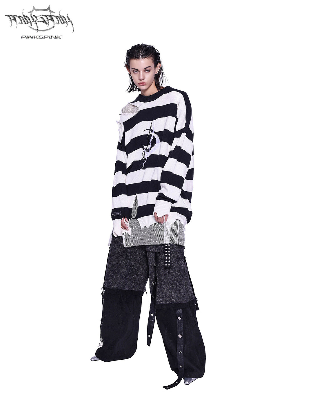 PINKSPINK ELECTRIC MOON distressed striped sweater in BLACK WHITE STRIPE — full-body front view styled with dark cargo trousers.