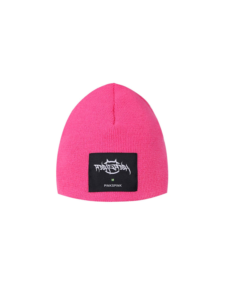 PINKSPINK GALAXY LIGHTNING logo knit beanie — pink knit beanie with black label patch, product-only view