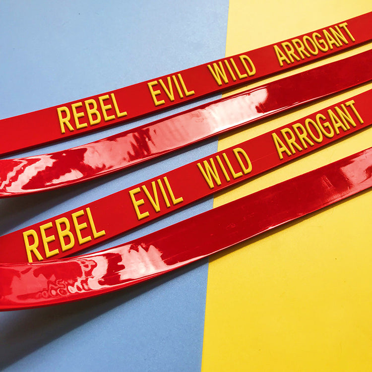 EOH-STUDIO BTBM red EVIL silicone straps showing the raised-letter front and glossy reverse.
