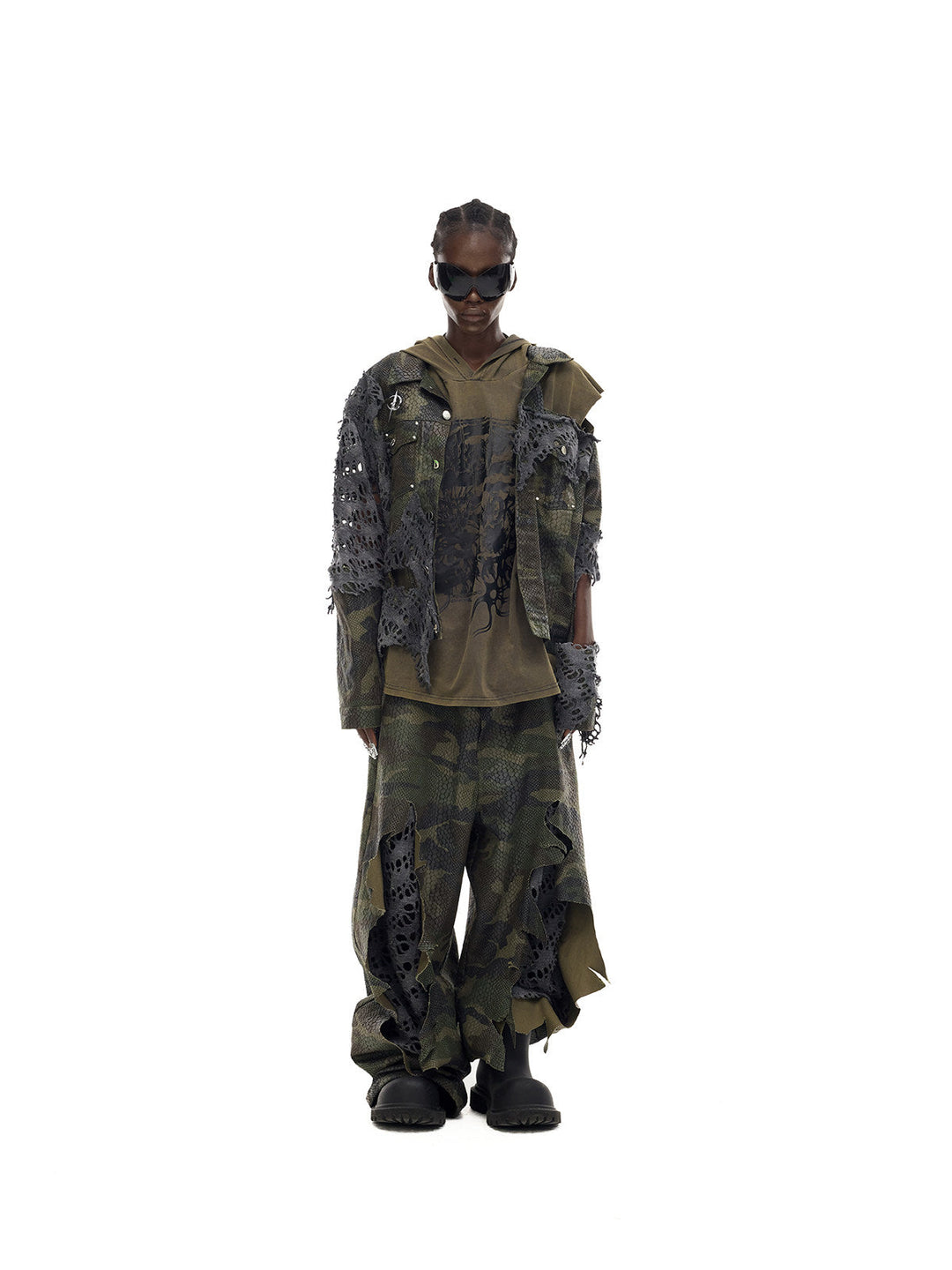 PINKSPINK DOUBLE STACK distressed camouflage wide-leg jeans — front full-length modeled view with sunglasses and an olive layer