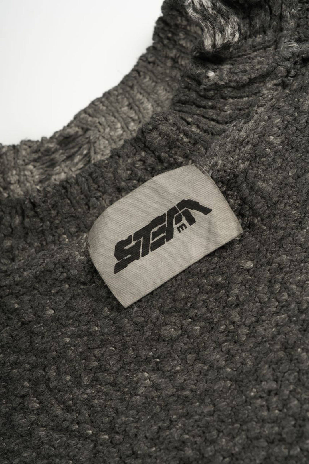 ARTEMIS distressed reversible knit sweater, close-up of the crew neckline and sewn-in STEAM label