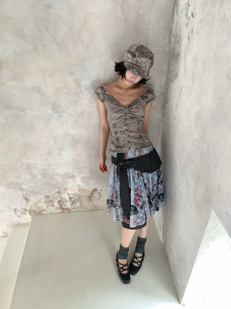4RE1GN CROSS RIBBON jacquard lace layered skirt in multicolor — high-angle modeled view styled with a ruffled vest and hat