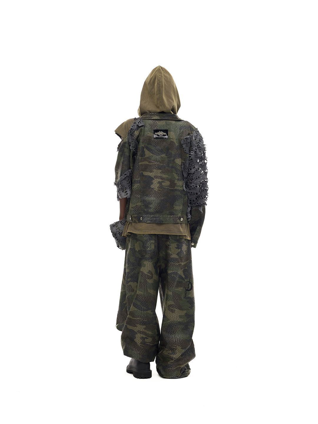 PINKSPINK ELECTRIC MOON distressed camouflage denim jacket — back full-length modeled view layered over an olive hooded top
