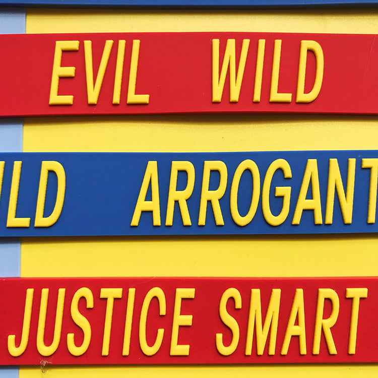 EOH-STUDIO BTBM raised yellow lettering on red and blue silicone, macro construction detail.